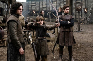From left to right: Jon Snow, Bran Stark, Rob Stark, and if you look closely little Rickon Stark in the background.